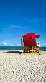 Colorful lifeguard tower on Miami Beach under a clear blue sky, perfect for a summer day.