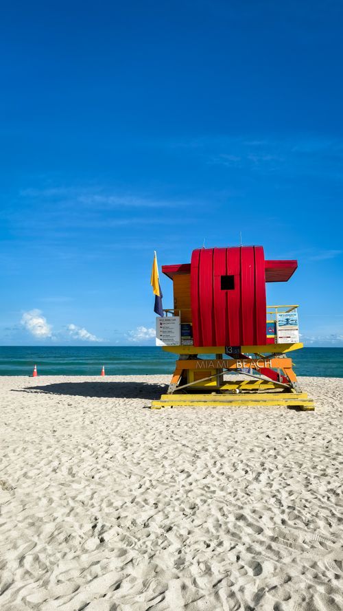 Free Colorful lifeguard tower on Miami Beach under a clear blue sky, perfect for a summer day. Stock Photo