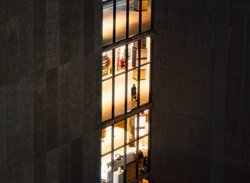 Free Aerial shot of a lit office building facade at night in Bangkok, Thailand, showcasing urban architecture. Stock Photo
