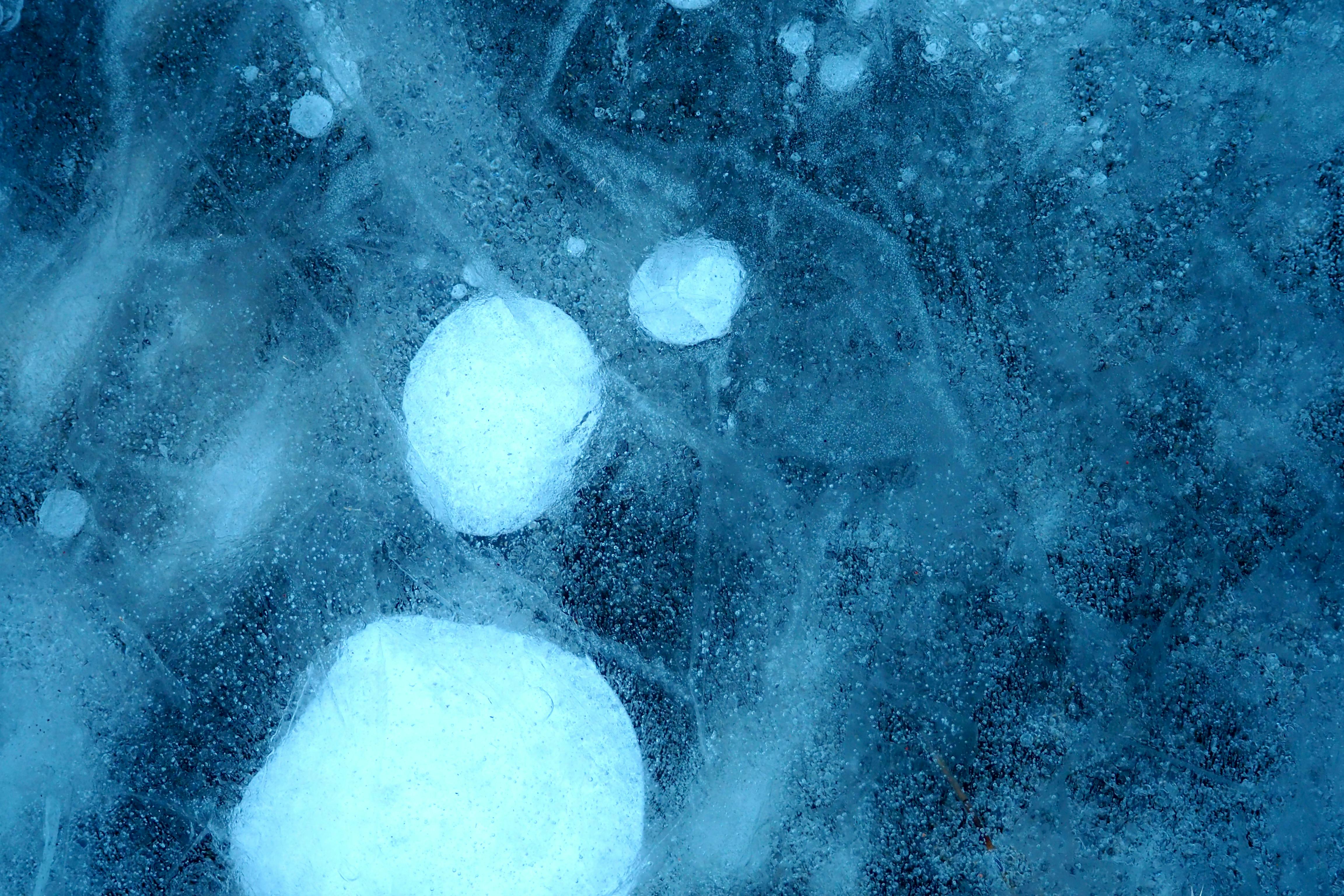 Free Detailed shot of frozen bubbles trapped in icy surface, showcasing winter's chill. Stock Photo