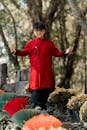 Young Adult in Traditional Red Garment Outdoors