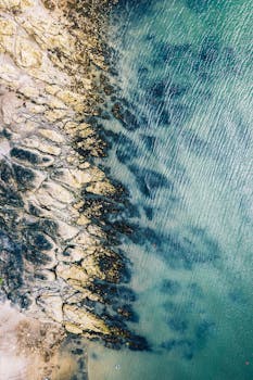 Stunning aerial view of the rocky shoreline and turquoise waters in Dublin, Ireland.