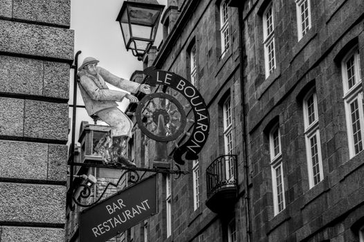 Black and white image of a vintage bar restaurant sign in Brittany, France.