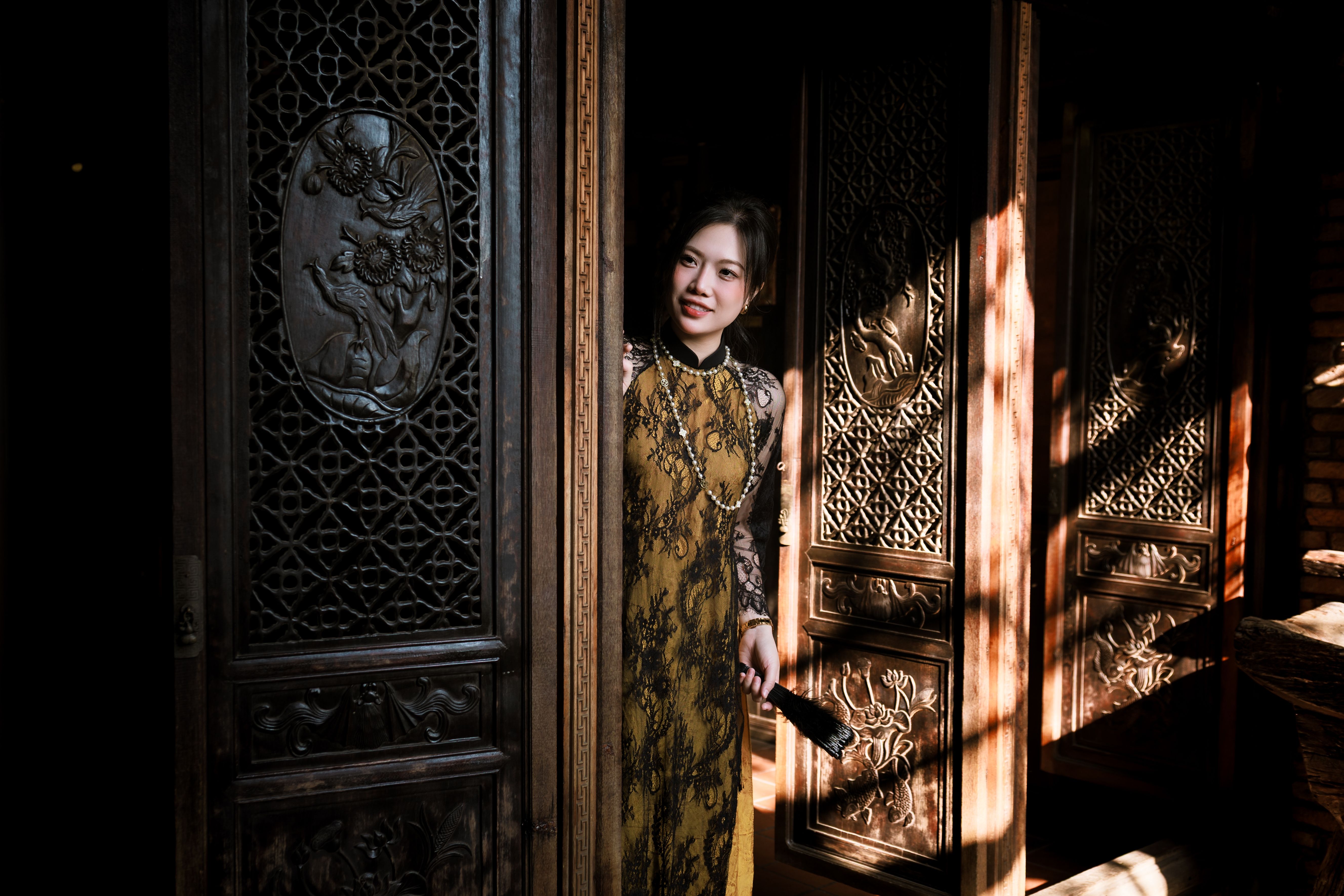 Elegant Woman in Traditional Dress at Ornate Doorway · Free Stock Photo