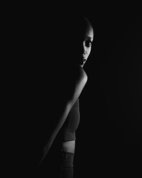 Dramatic black and white portrait of a woman in low key lighting.. dramatic, black, white