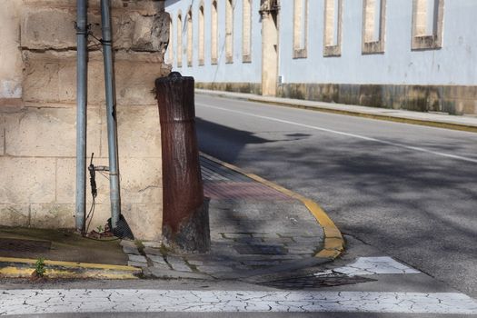 Street corner in El Puerto de Santa María showing rustic architecture and empty road.