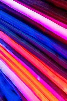 An abstract display of multicolored fabric textures showcasing vibrant patterns and colors.