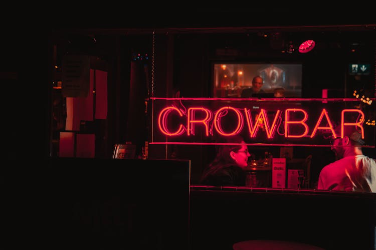 A Man And A Woman Having Fun In A Bar