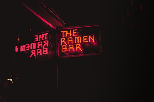 Vibrant neon sign of The Ramen Bar glowing at night in Dublin.