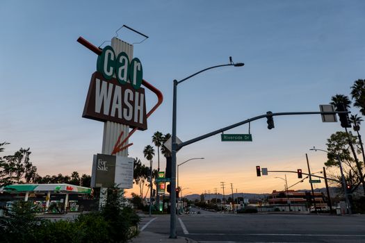 A nostalgic car wash sign on Riverside Drive at sunset, capturing the classic American roadside vibe.
