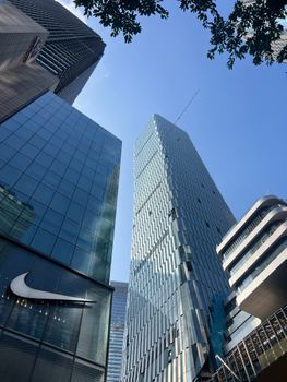 Innovative architecture of Chongqing's skyscrapers reaching towards a clear blue sky.