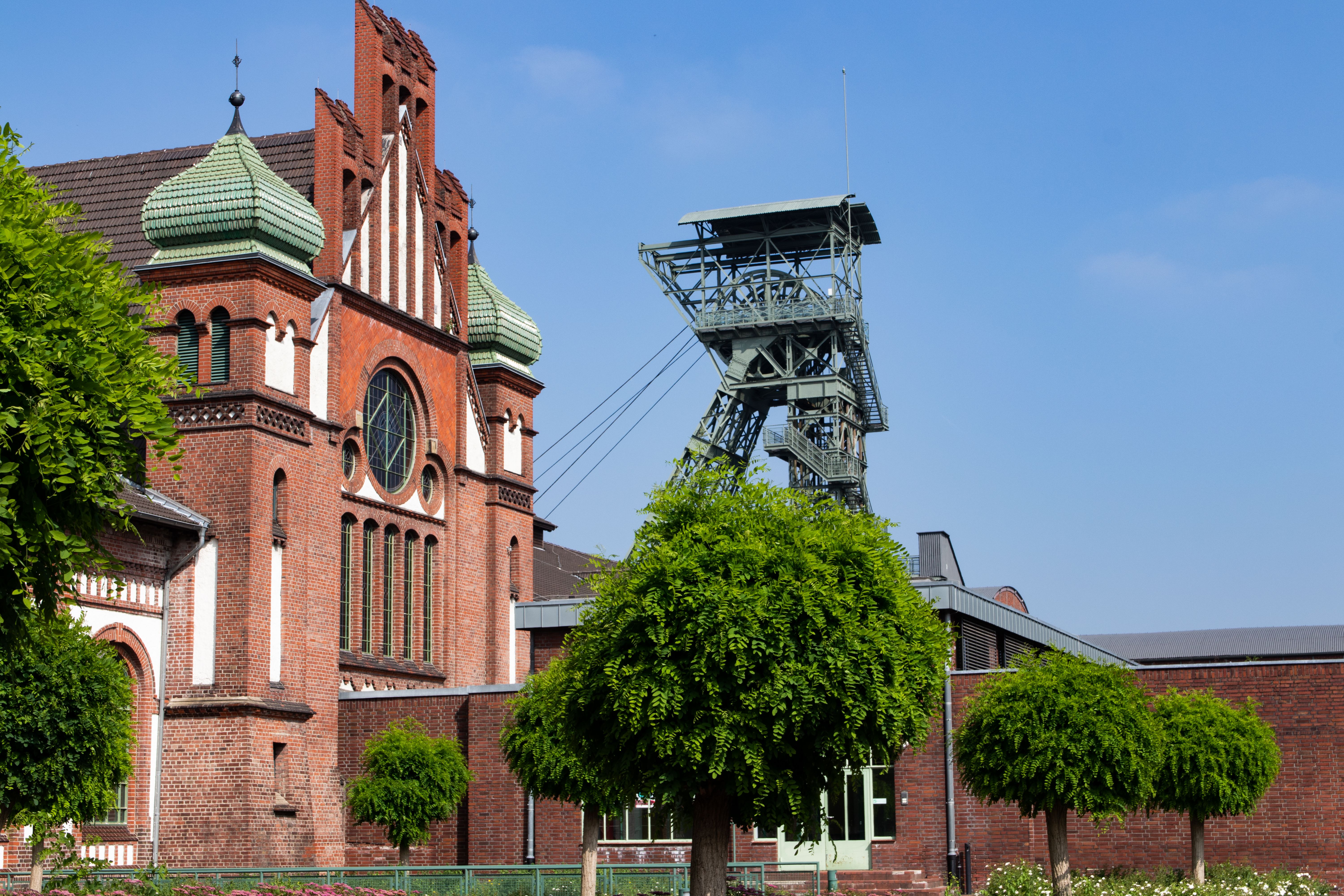Historic Industrial Building with Mining Tower · Free Stock Photo