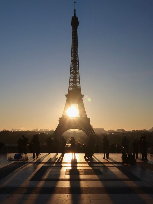 Free Captivating silhouette of the Eiffel Tower at sunrise with people in Paris, France. Stock Photo