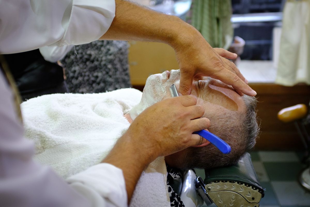 Heritage Barber Co. — traditional straight-razor shave in progress