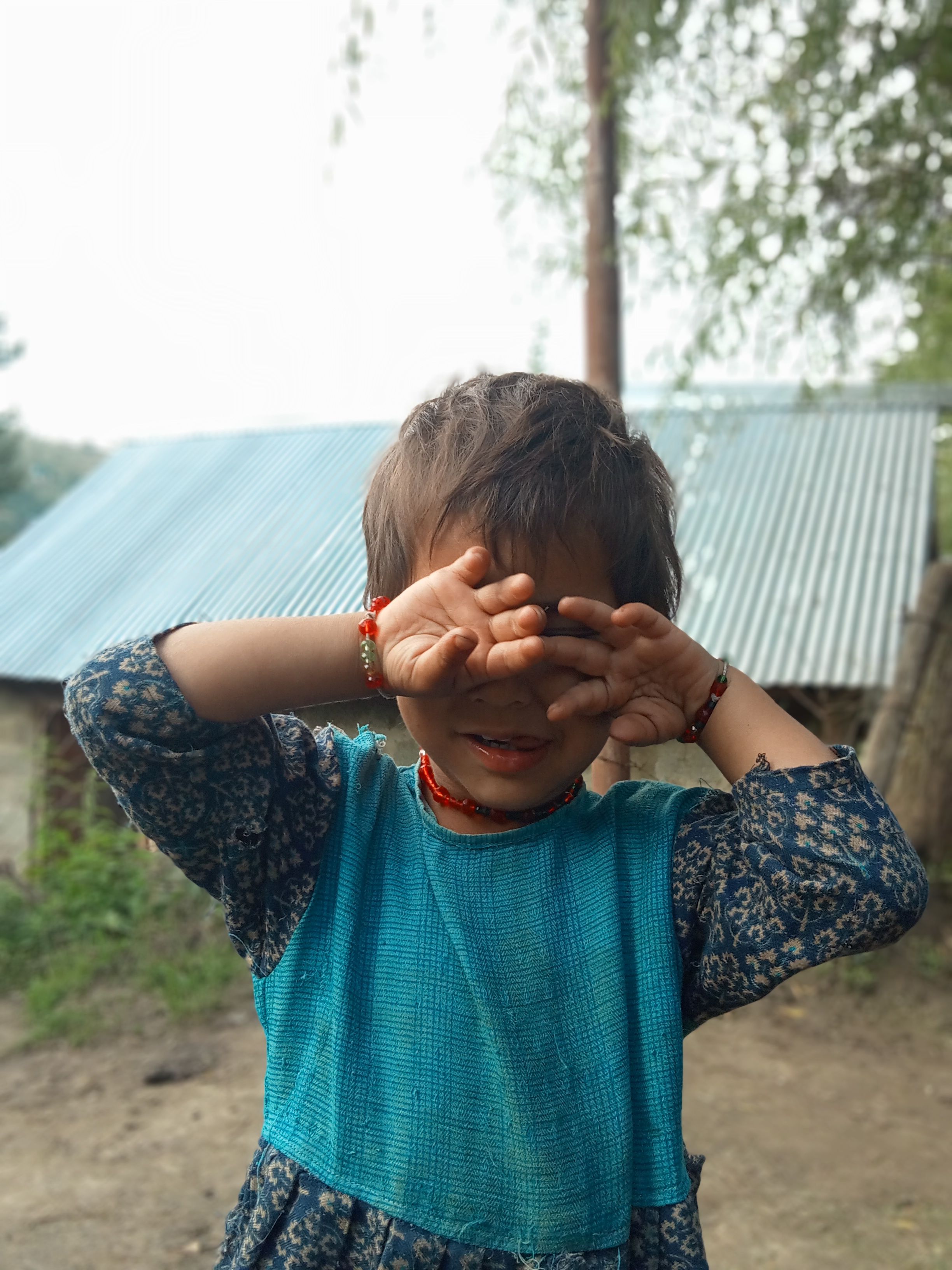Child playing outdoors in colorful casual clothes