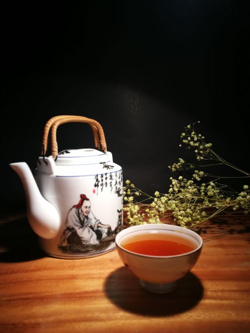 Free Artistic still life featuring a traditional teapot and tea cup with flowers. Perfect for tea culture enthusiasts. Stock Photo