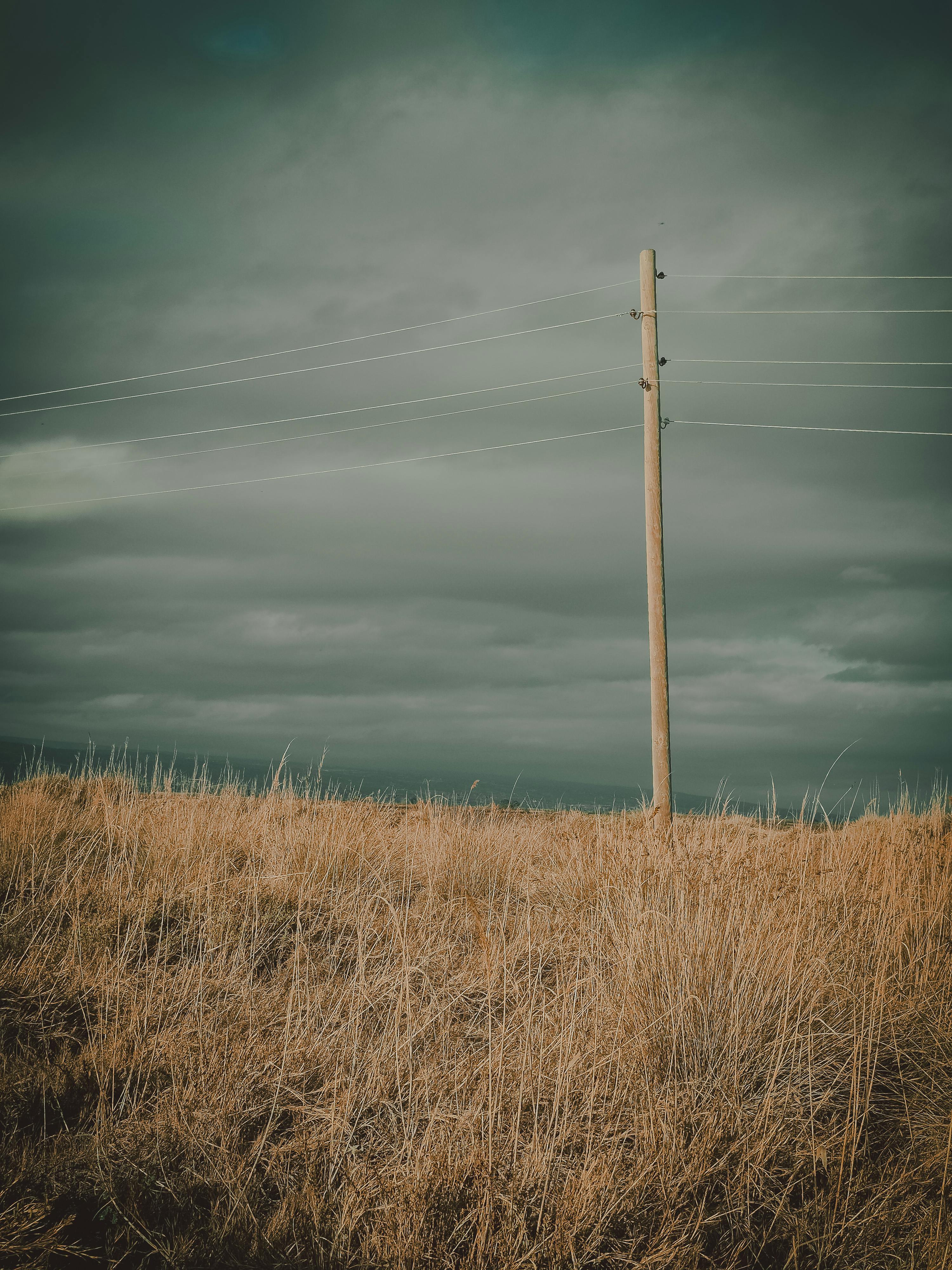 Free Moody landscape in Silifke, Türkiye with a lone power pole and dramatic sky. Stock Photo