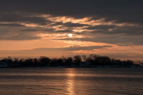 Free Gorgeous sunrise over Cove Island Park in Stamford with reflections and a serene winter ambiance. Stock Photo