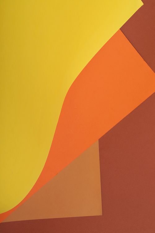Free Bright abstract composition featuring overlapping yellow, orange, and brown paper layers. Stock Photo
