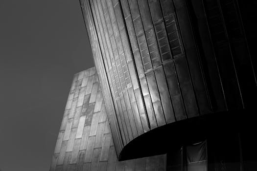 Dramatic black and white photo of modern architectural structure with dramatic light.