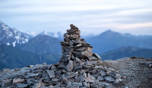 Free A tranquil stone cairn stands against a majestic alpine mountain backdrop, symbolizing respect and guidance. Stock Photo