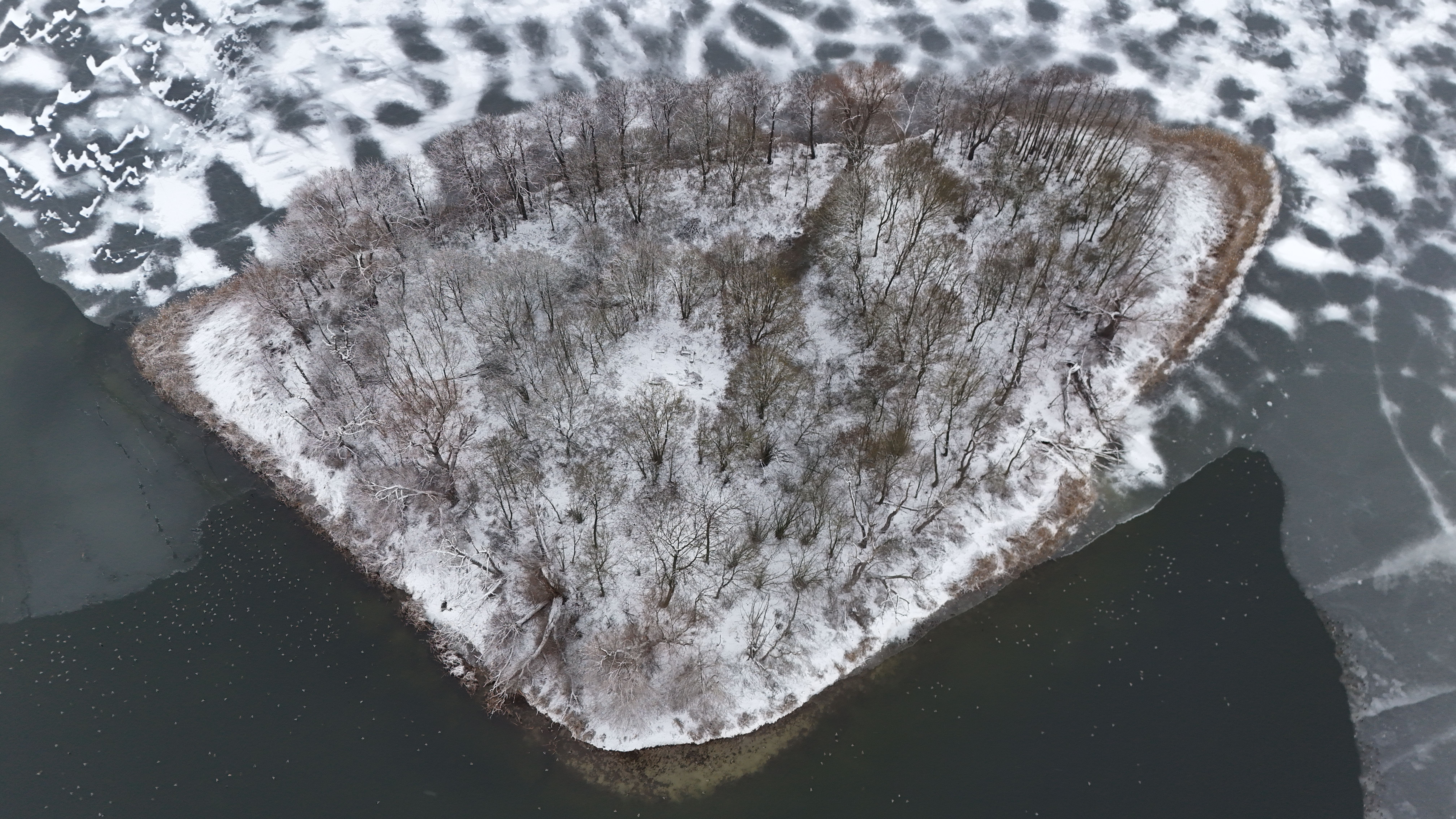 Aerial View of Snow-Covered Island Amidst Frozen Lake · Free Stock Photo