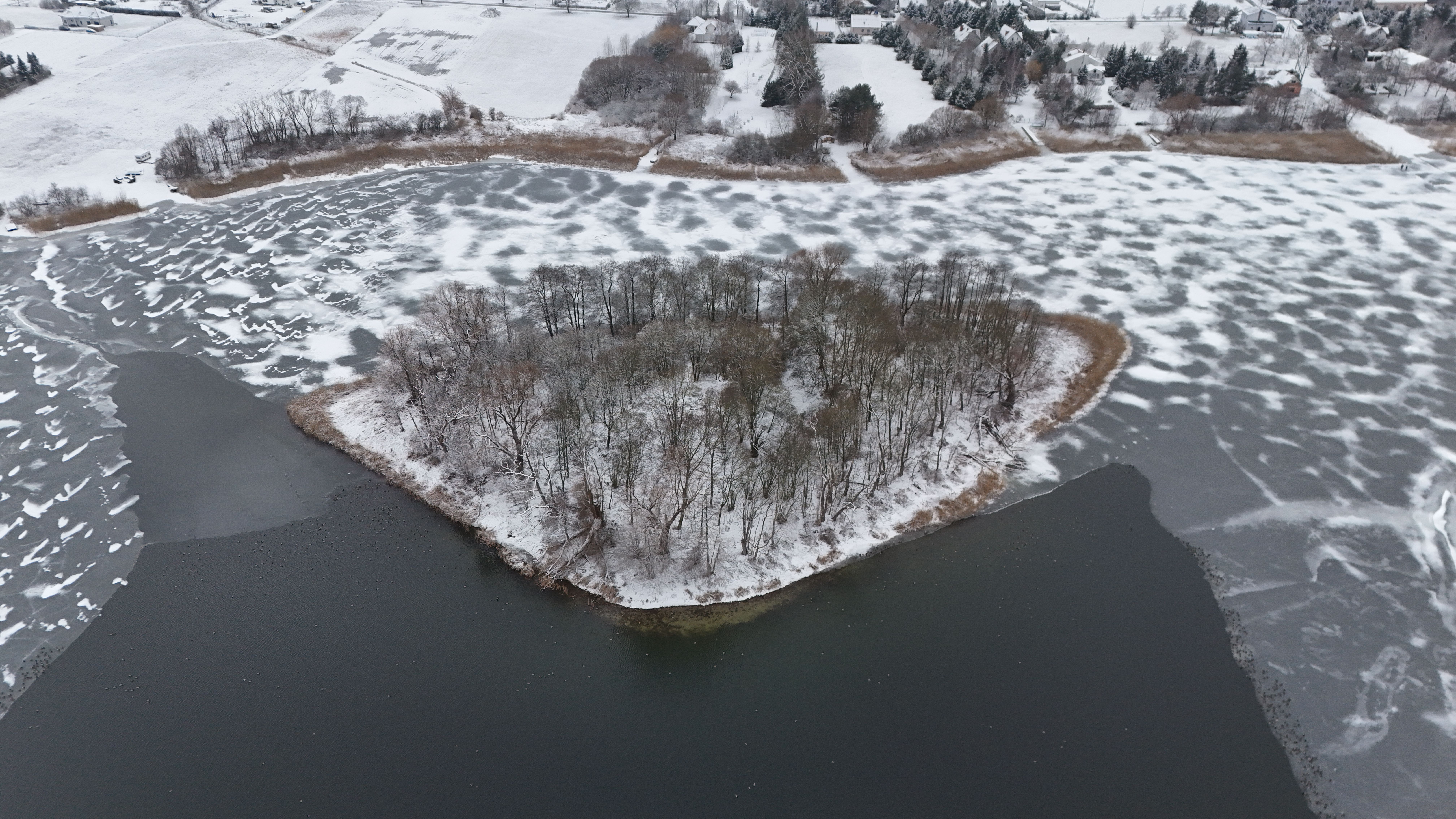 Aerial View of Frozen Lake with Snow-Covered Island · Free Stock Photo