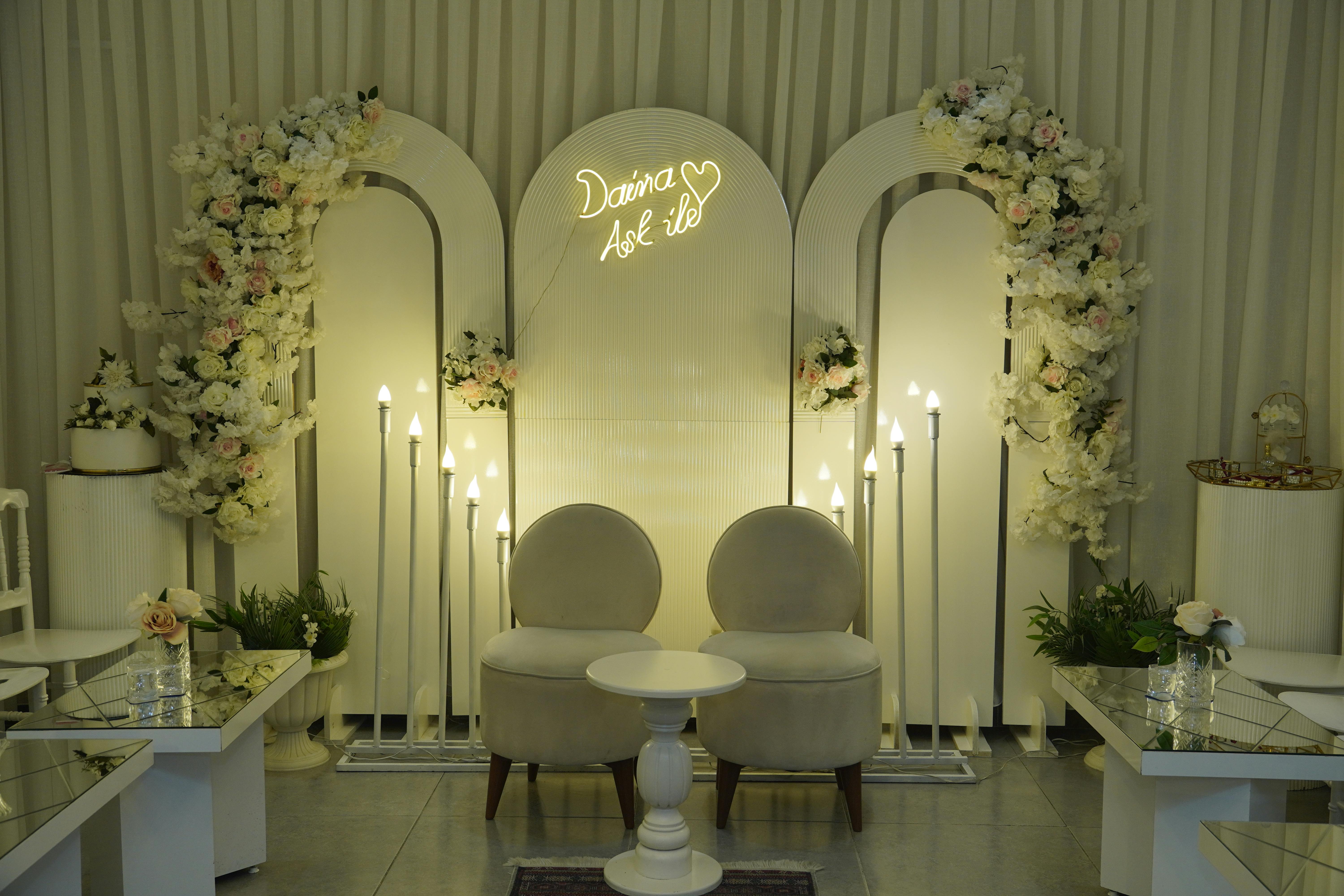 Sophisticated wedding ceremony setup with floral arrangements and elegant lighting.