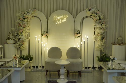 Free Sophisticated wedding ceremony setup with floral arrangements and elegant lighting. Stock Photo