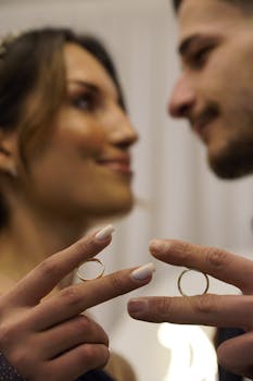 Close-up of a couple's hands exhibiting wedding rings, capturing a moment of love and commitment.