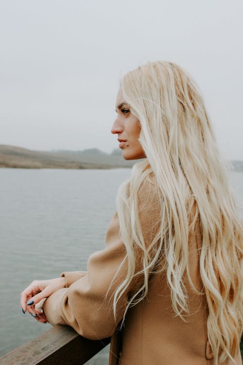 Free Woman Standing  Near Body of Water Stock Photo