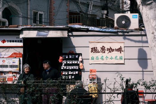 A cozy street view of a small shop in Shanghai, China showcasing everyday local life.