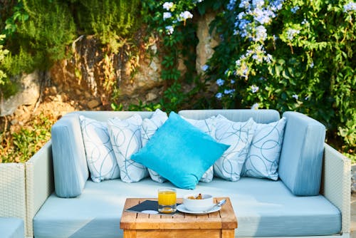 Blue Throw Pillow and Brown Wooden Table