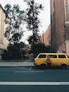 Person Standing Near Yellow Van on Road