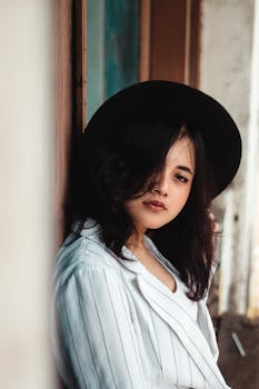 Beautiful portrait of an Asian woman wearing a black hat, exuding a moody vibe.