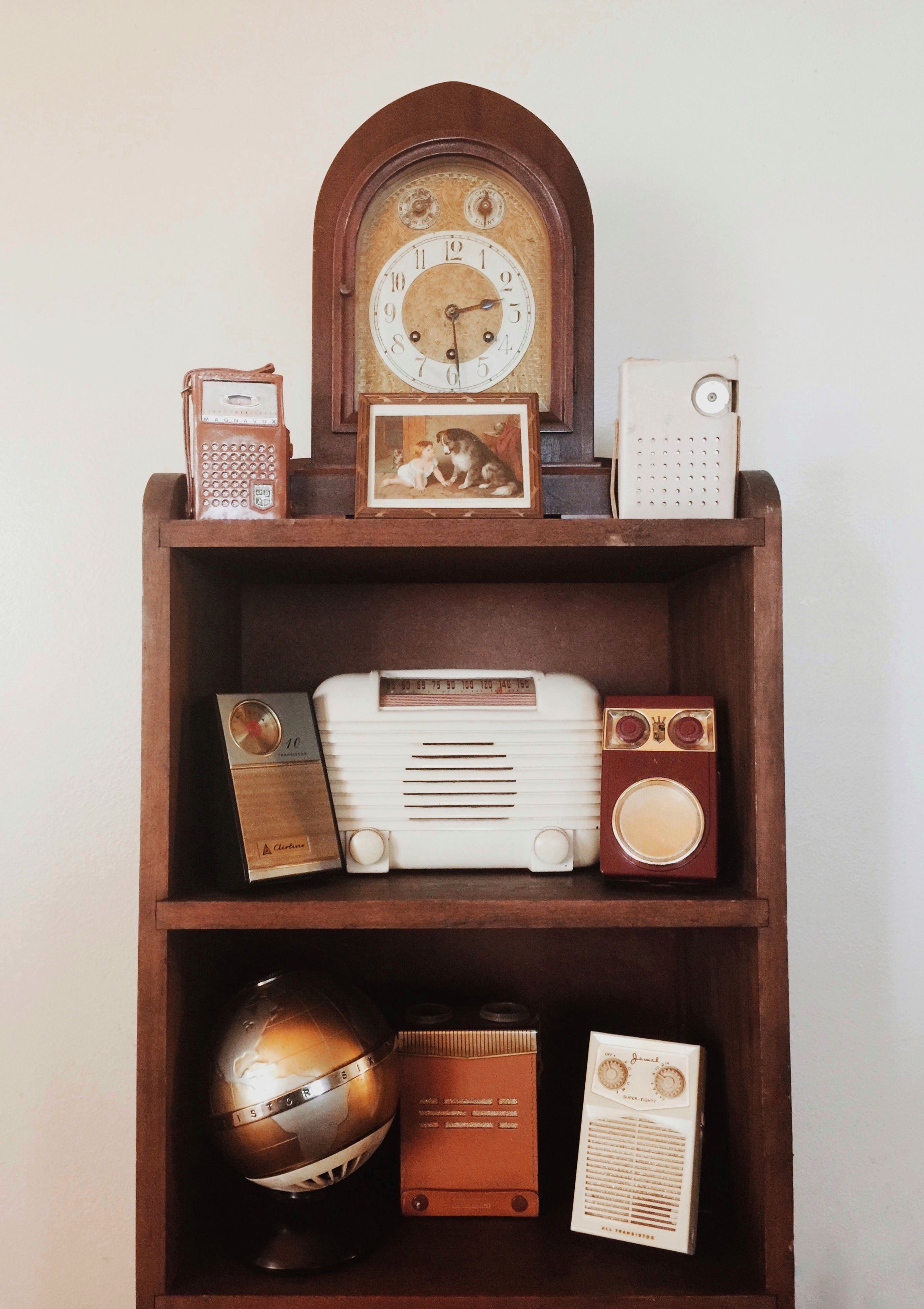 Vintage radios on a wooden shelf