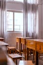Sunlit Classroom with Empty Wooden Desks