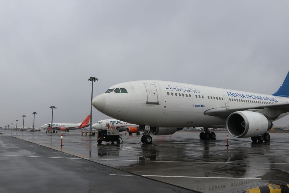 Traveler speaking with airline staff at Yerevan Zvartnots International Airport counter