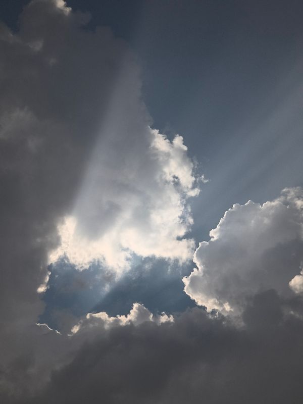 Dramatic Sun Rays Breaking Through Storm Clouds · Free Stock Photo