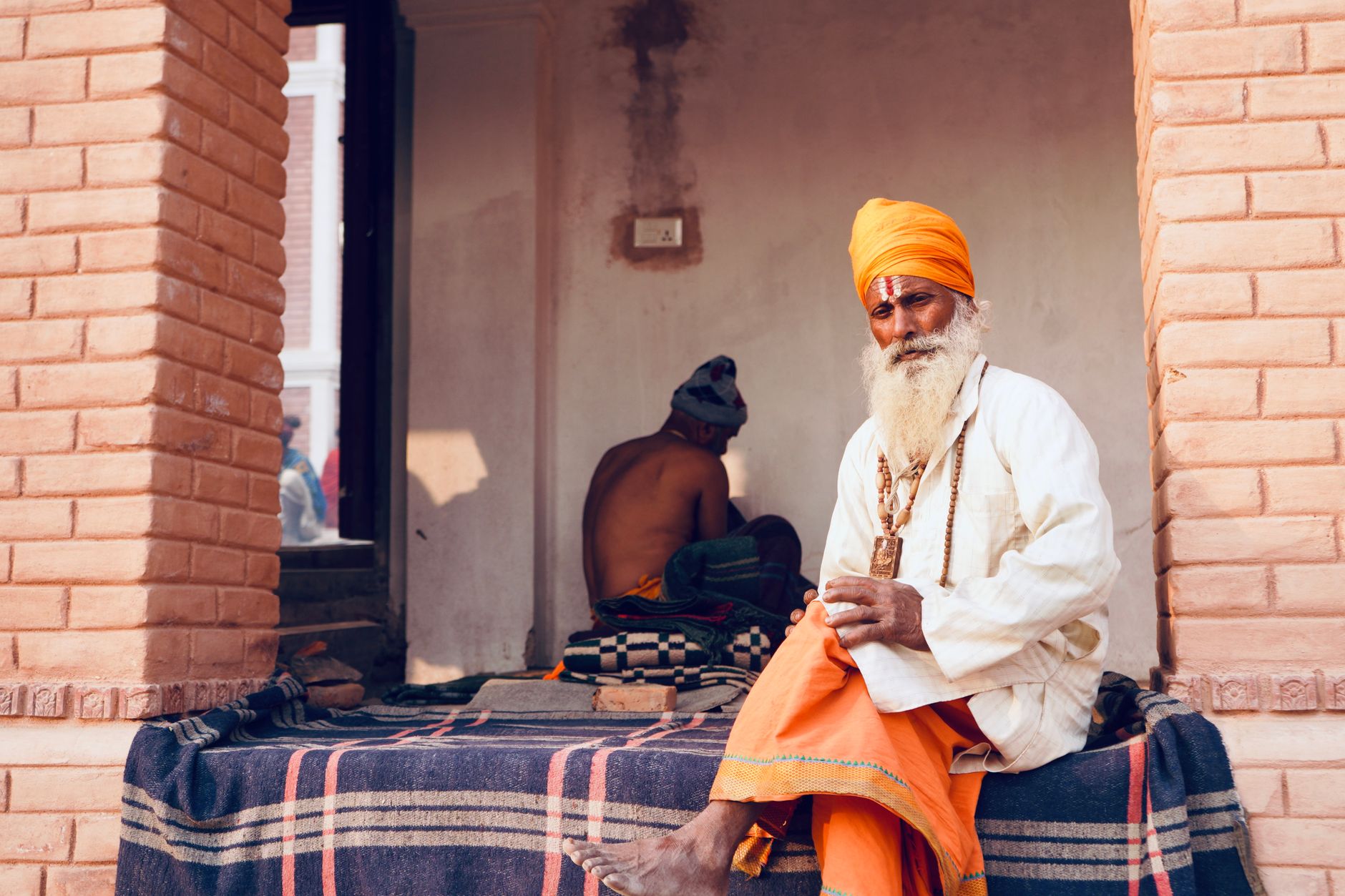 A Hindu Sadhu dressed in vibrant attire at Pashupatinath Temple, Kathmandu, Nepal, showcasing spiritual heritage.