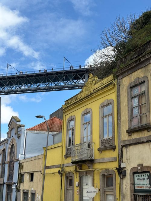 Free Colorful buildings in Vila Nova de Gaia with Dom Luís I Bridge overhead. Stock Photo