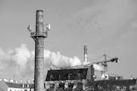 Industrial Chimneys and Crane in Urban Landscape