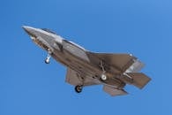 Military Fighter Jet F35 in Mid-Flight Against Blue Sky