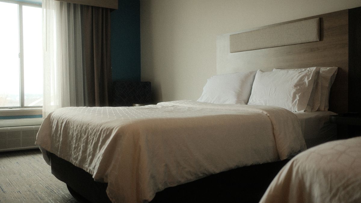 Peaceful hotel room with luxurious bedding, perfect for a relaxing stay and comfortable sleep.