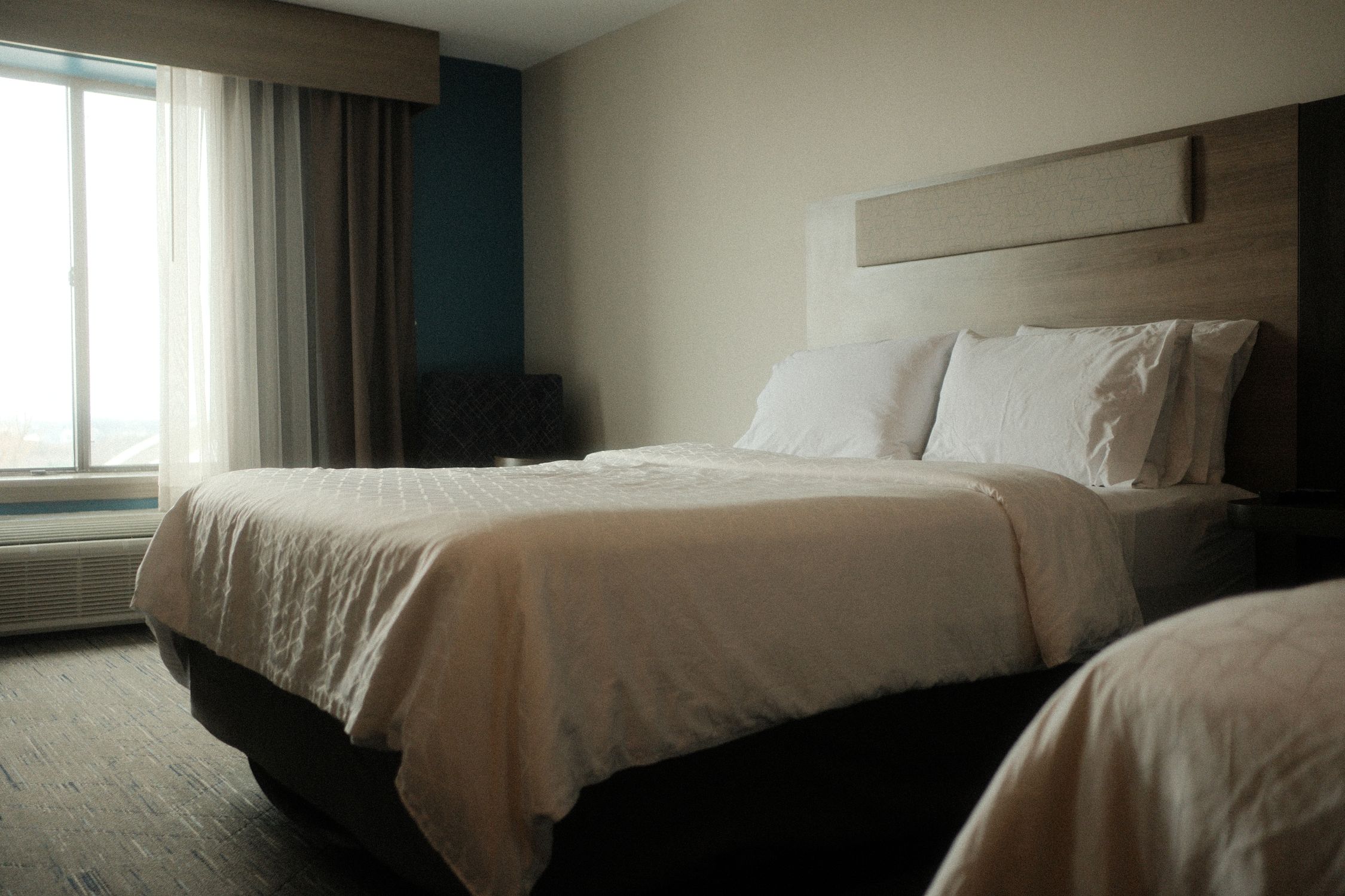 Peaceful hotel room with luxurious bedding, perfect for a relaxing stay and comfortable sleep.