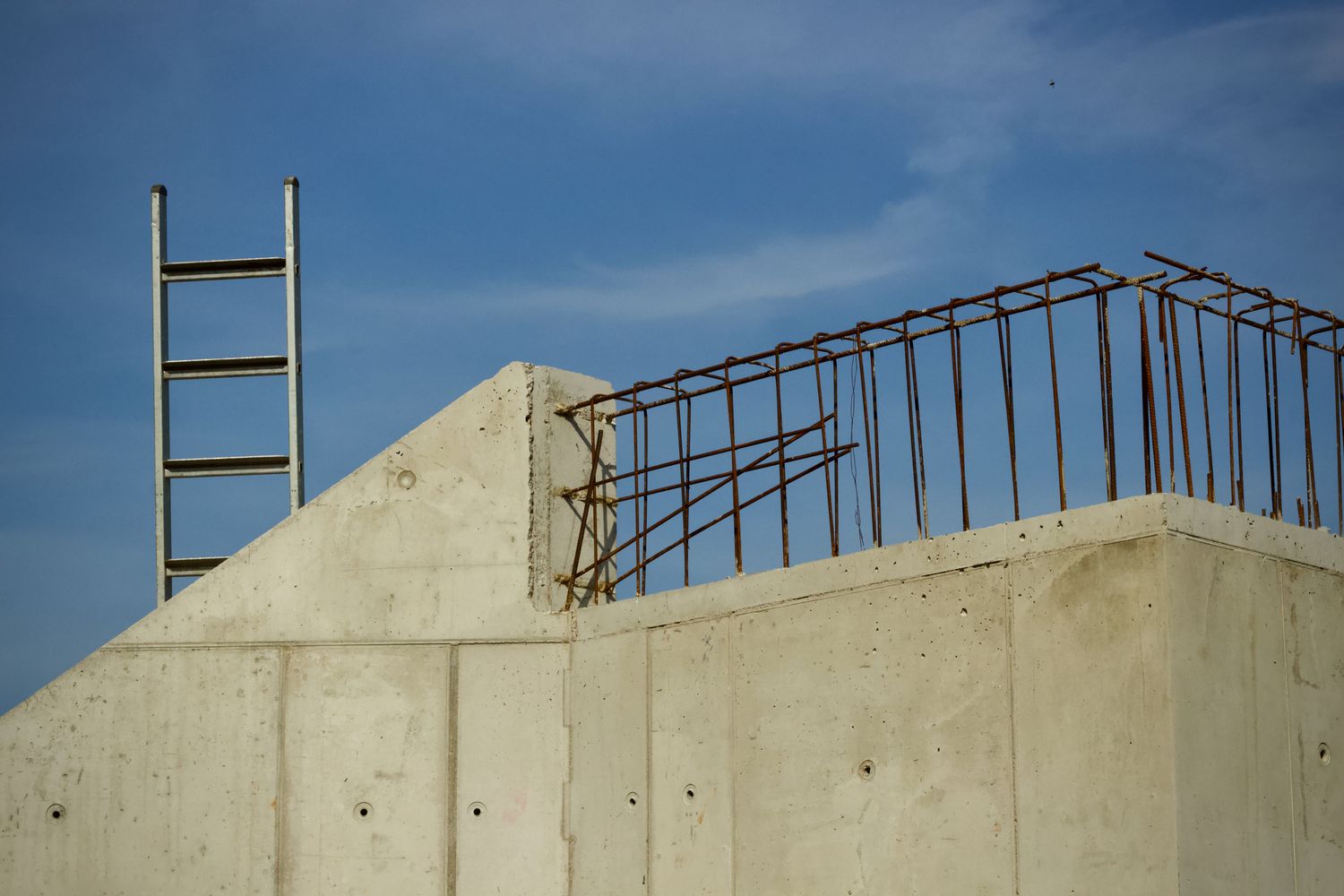 Concrete structure with rebar and a ladder under construction