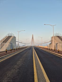 Captivating view of a modern suspension bridge under a clear morning sky.