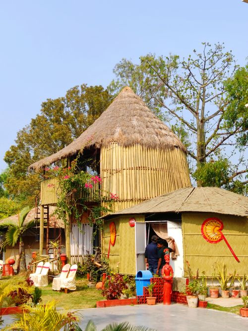 Free Charming bamboo hut with thatched roof amidst lush greenery. Perfect rustic getaway scene. Stock Photo