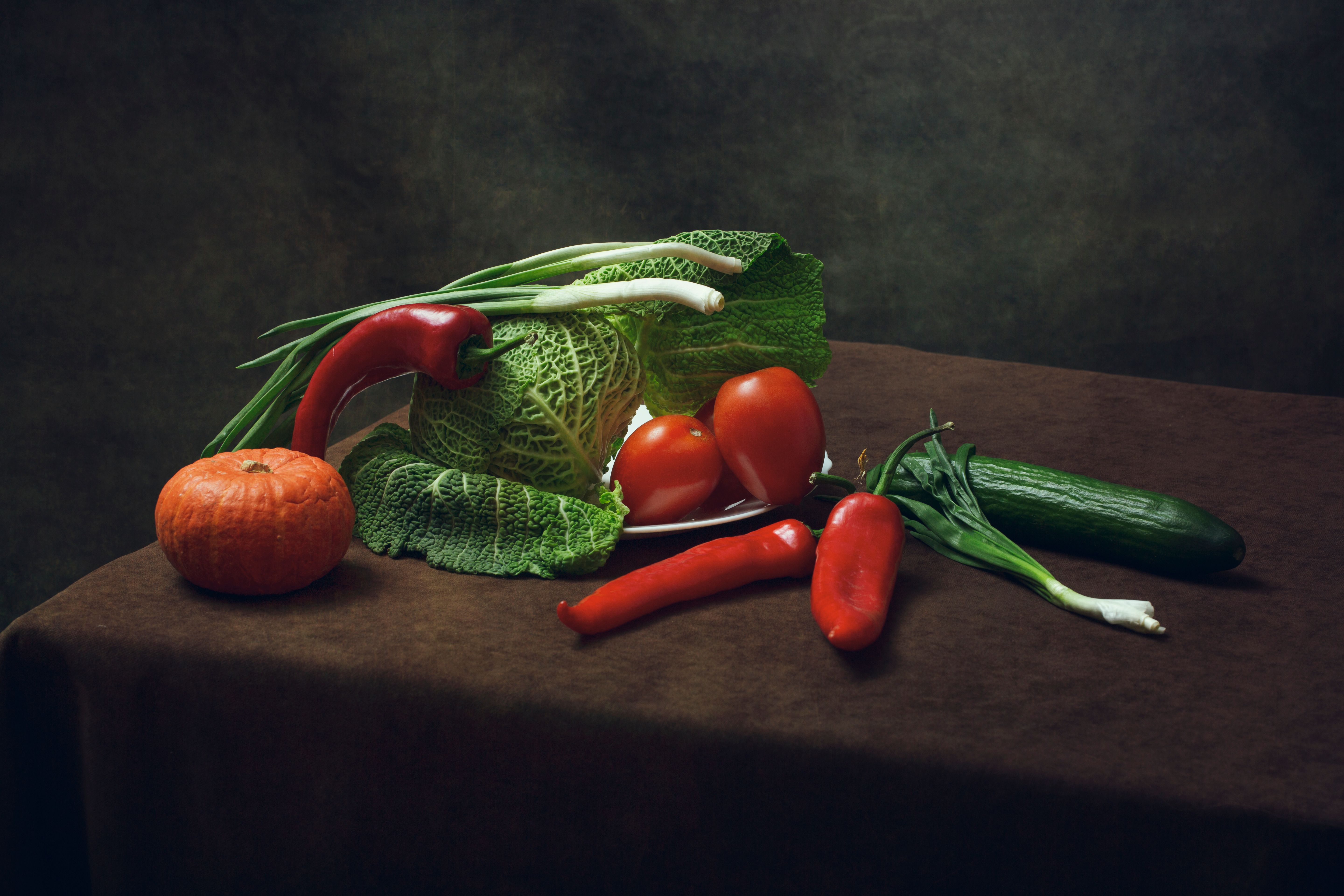 An artistic still life of fresh vegetables on a table, showcasing vibrant produce.