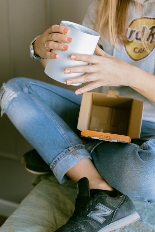 Photo of hands holding a white mug